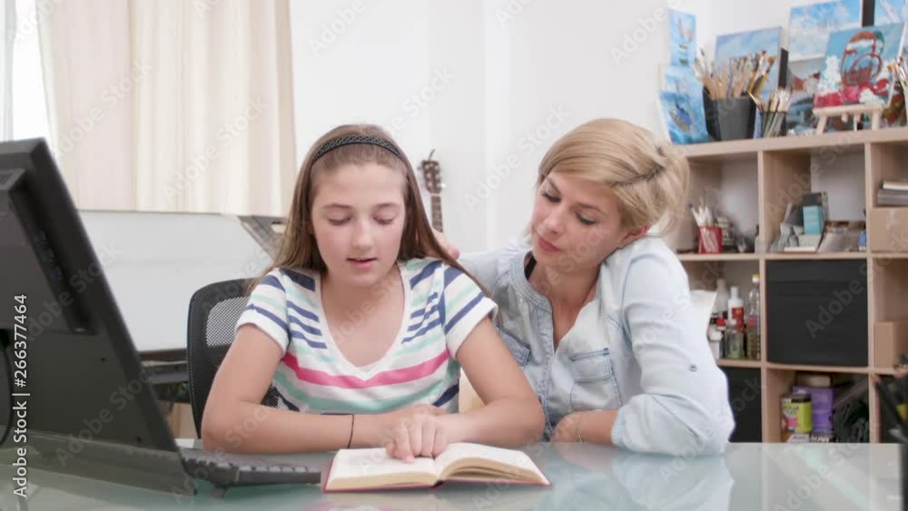 Loving mother and her teenage girl reading a book together. Parent and her kid reading a story from a book. Loving mother and her teenage girl reading a book together. Parent and her kid reading a story from a book.