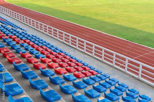 Empty seats in football field grand soccer arena with running tracks in sport stadium.
