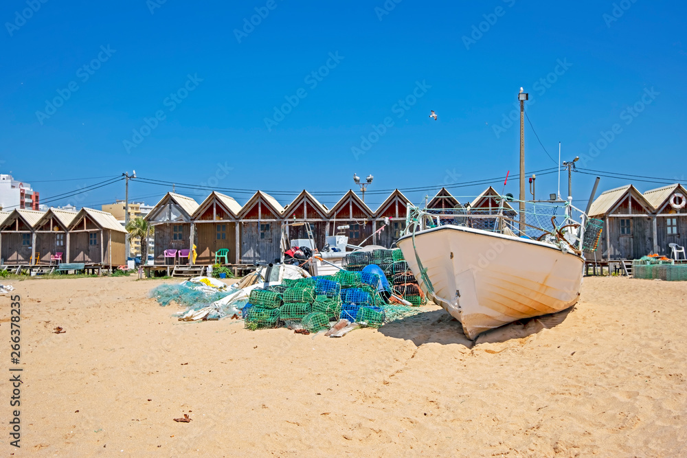 Traditonal fisherman huts on the beach in Armacao de Pera in the Algarve Portugal Traditonal fisherman huts on the beach in Armacao de Pera in the Algarve Portugal