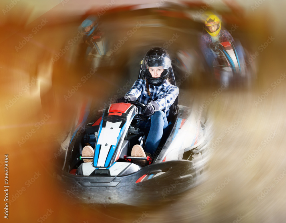 Group of people driving go-carts at racing track