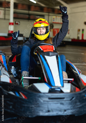 Woman driving sport car for karting in a circuit lap in sport club