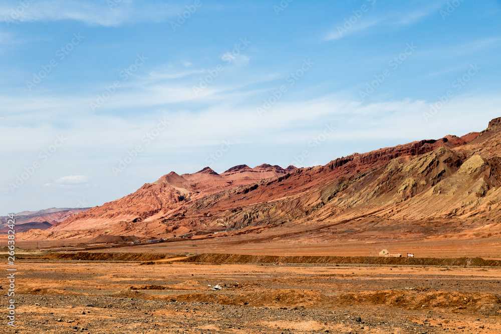 Flaming mountains, Turpan, Xinjiang, China: these intense red arid mountains similar to scorching flames appear in the Chinese epic “Journey to the west”. Turpan is an ancient oasis on the Silk Road Flaming mountains, Turpan, Xinjiang, China: these intense red arid mountains similar to scorching flames appear in the Chinese epic “Journey to the west”. Turpan is an ancient oasis on the Silk Road