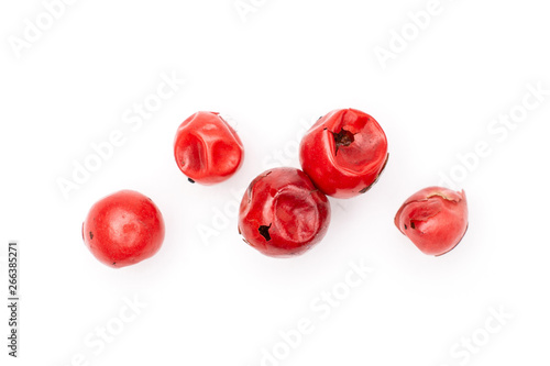 Group of five whole peruvian pink pepper macro flatlay isolated on white background
