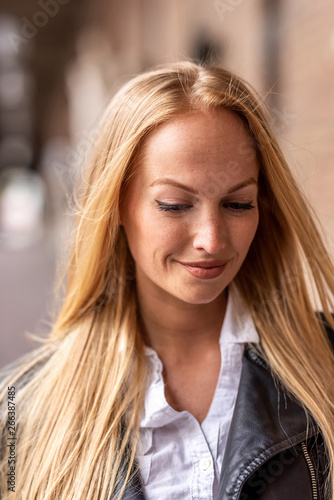 Portrait of a woman in front of a historic building