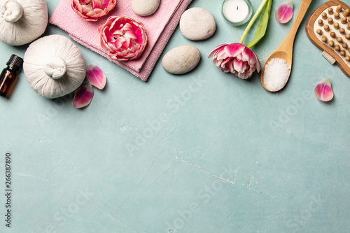 Flat lay of spa treatment set with pink flowers