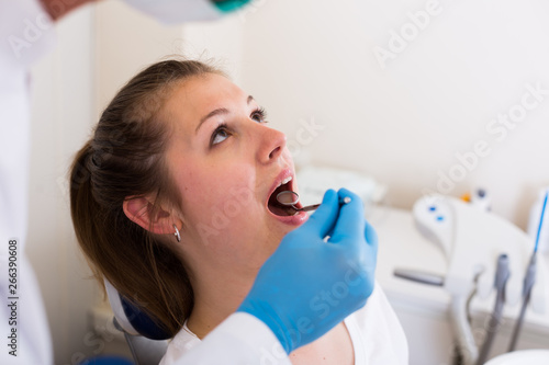 Professional in uniform is taking a view of a patient