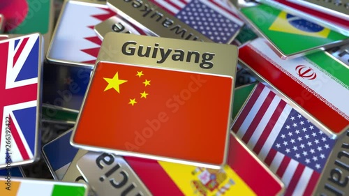 Souvenir magnet or badge with Guiyang text and national flag among different ones. Traveling to China conceptual intro animation photo