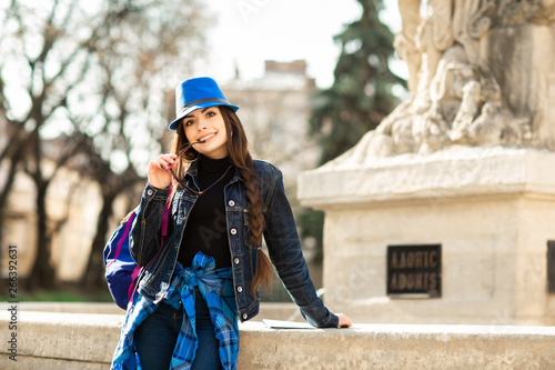 Young stylish woman in blue hat, walking on the old town street. Ukraine, Lviv
