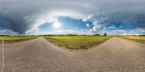 Full spherical seamless panorama 360 degrees angle view on no traffic asphalt road among alley and fields with awesome clouds in equirectangular equidistant projection, VR AR content