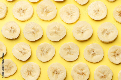 Creative summer pattern made of bananas slice on pastel yellow background. Fruit minimal concept. Flat lay.