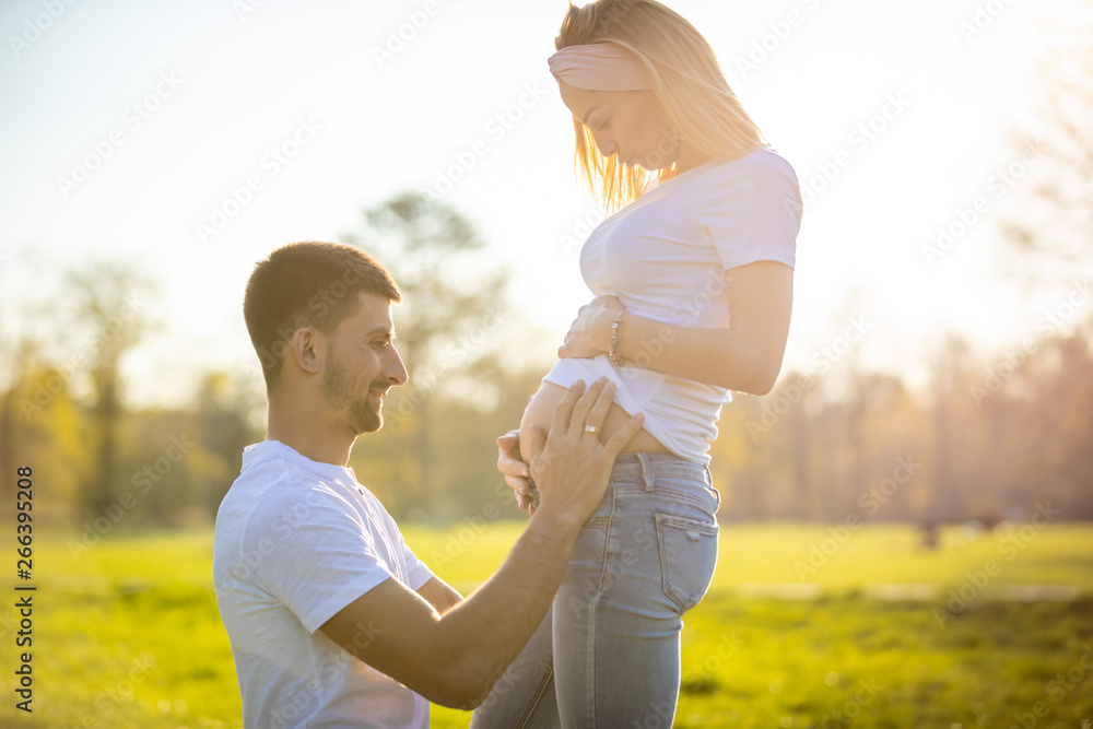 Fototapeta premium Happy couple expecting baby, pregnant woman with husband, young family and new life concept