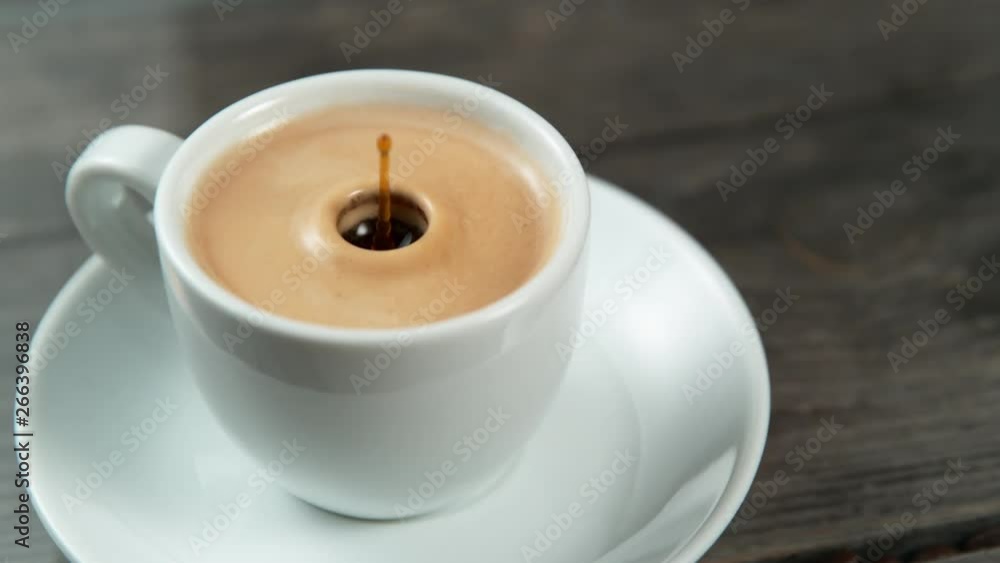 Drop falling into a cup of coffee in super slowmotion. Drop falling into a cup of coffee in super slowmotion.