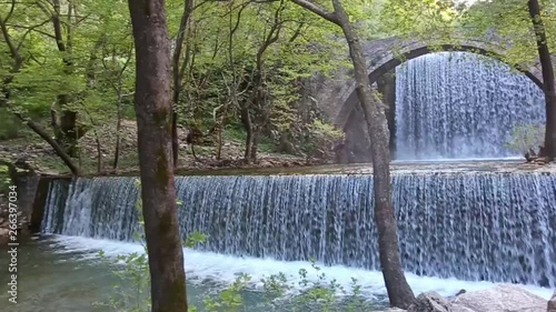 double waterfalls of Palaiokaria in Trikala Thessaly Greece - stony arched bridge between the two waterfalls photo