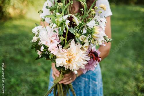 Woman holding large bouquet of flowers. photo