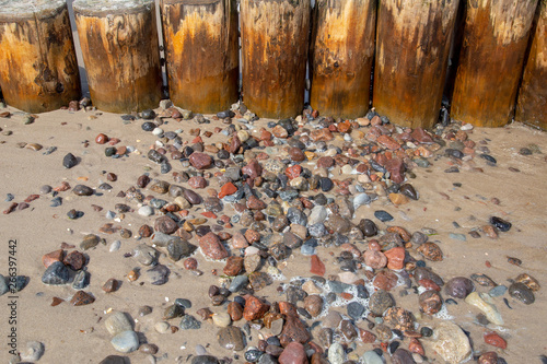 Buhnen with washed stones on the beach of the Baltic Sea in the seaside resort Zempin on Usedom photo