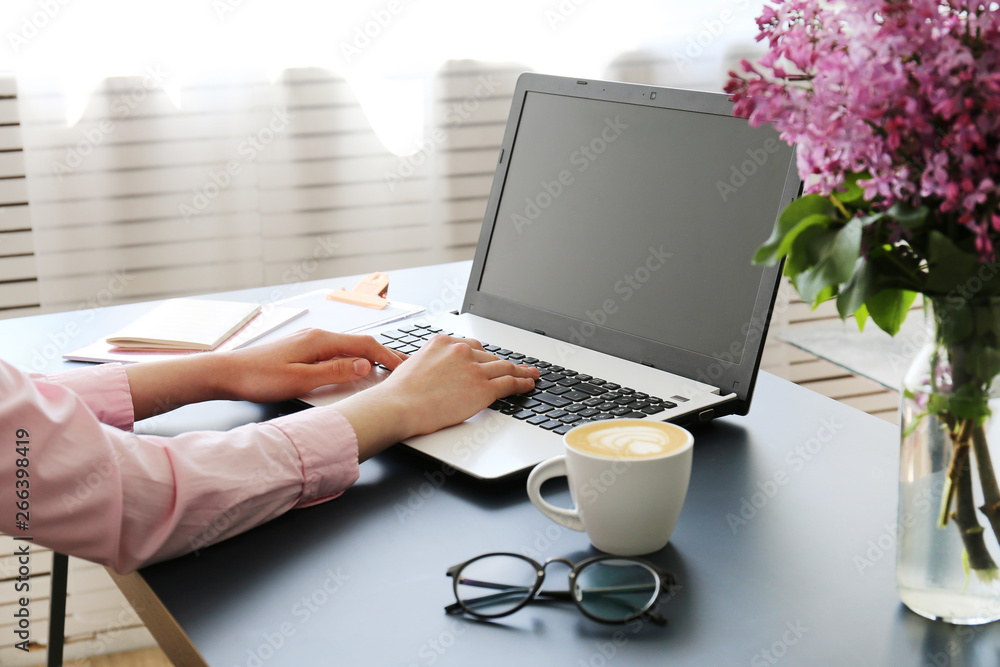 Feminine freelance workspace concept. Woman's hands typing on white laptopp with black keyboard, desk with matte blue table top. Freelance blogger writing an article. Close up, copy space for text. Feminine freelance workspace concept. Woman's hands typing on white laptopp with black keyboard, desk with matte blue table top. Freelance blogger writing an article. Close up, copy space for text.