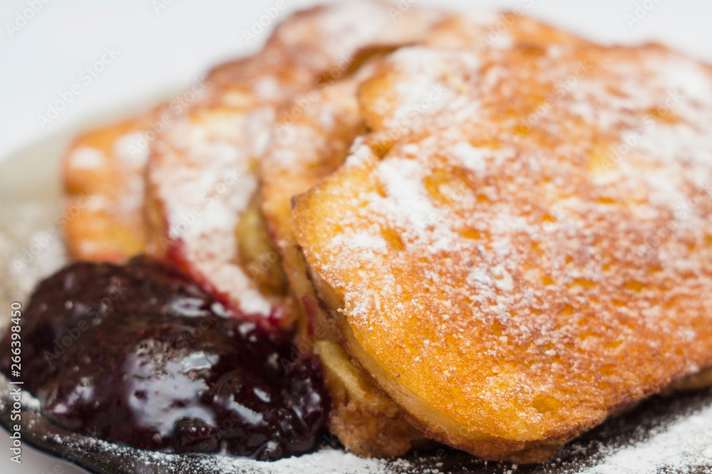 french toast with jam on black plate french toast with jam on black plate