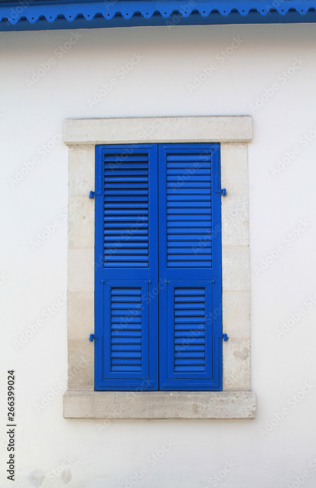 window with closed blue wooden shutters window with closed blue wooden shutters