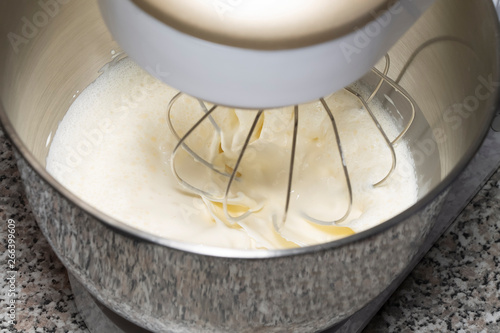 The process of whipping of batter in a planetary mixer. Selective focus.