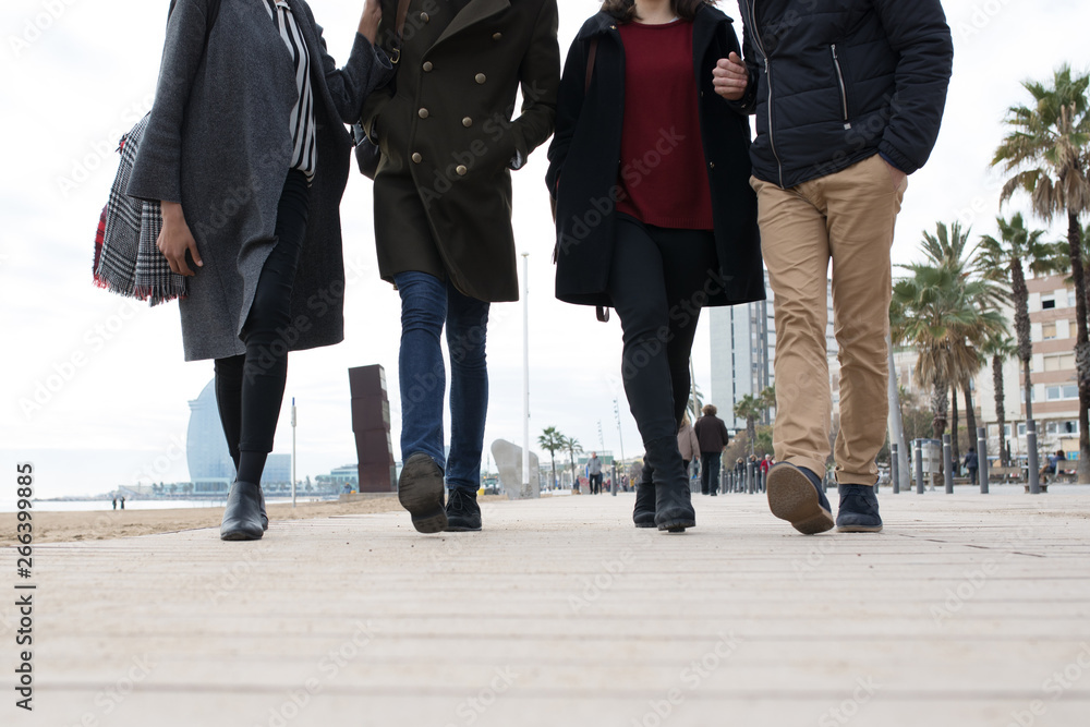Faceless people walking on wooden waterfront. Faceless people walking on wooden waterfront.