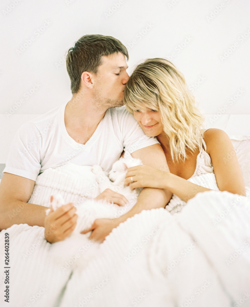 Couple with cat in bed Couple with cat in bed