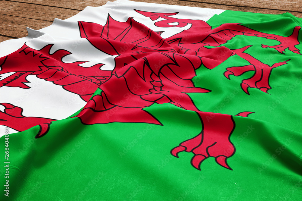 Φωτογραφία Flag of Wales on a wooden desk background