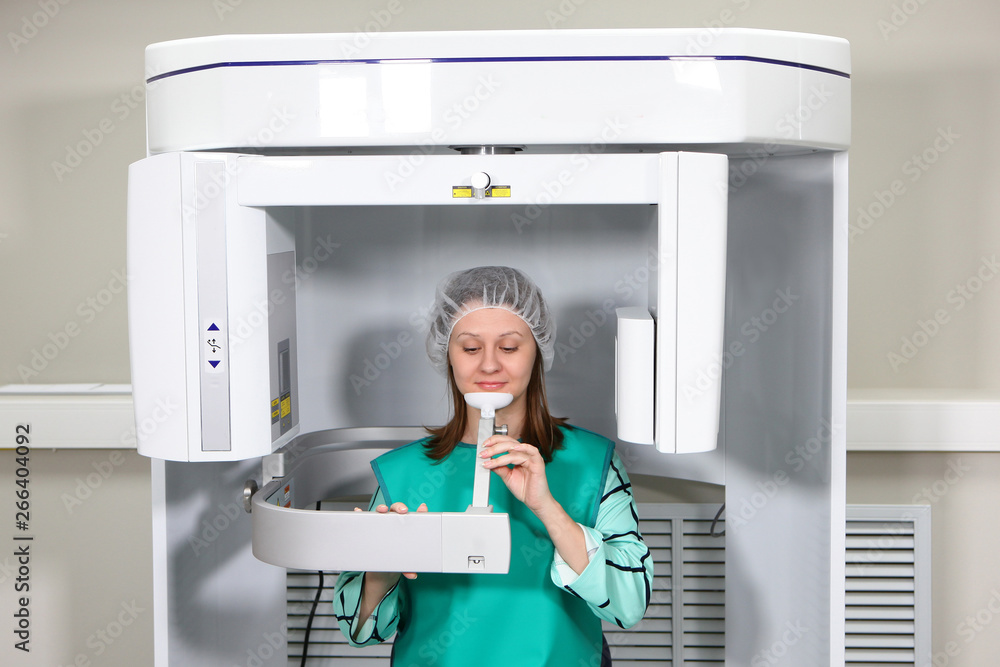 A young patient of the dental clinic makes a panoramic shot of the jaw on a modern apparatus. Modern technologies in dentistry and medicine. The concept of health and beauty. A young patient of the dental clinic makes a panoramic shot of the jaw on a modern apparatus. Modern technologies in dentistry and medicine. The concept of health and beauty.