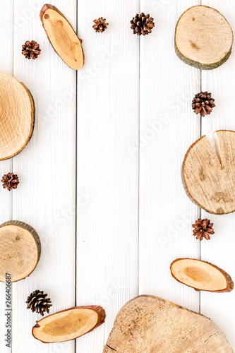 wooden sawcut and pine cone frame for blog on white background top view mockup