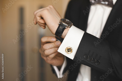 Quadro su tela Close view of the luxury watches on the hand of a handsome businessman in a tuxe