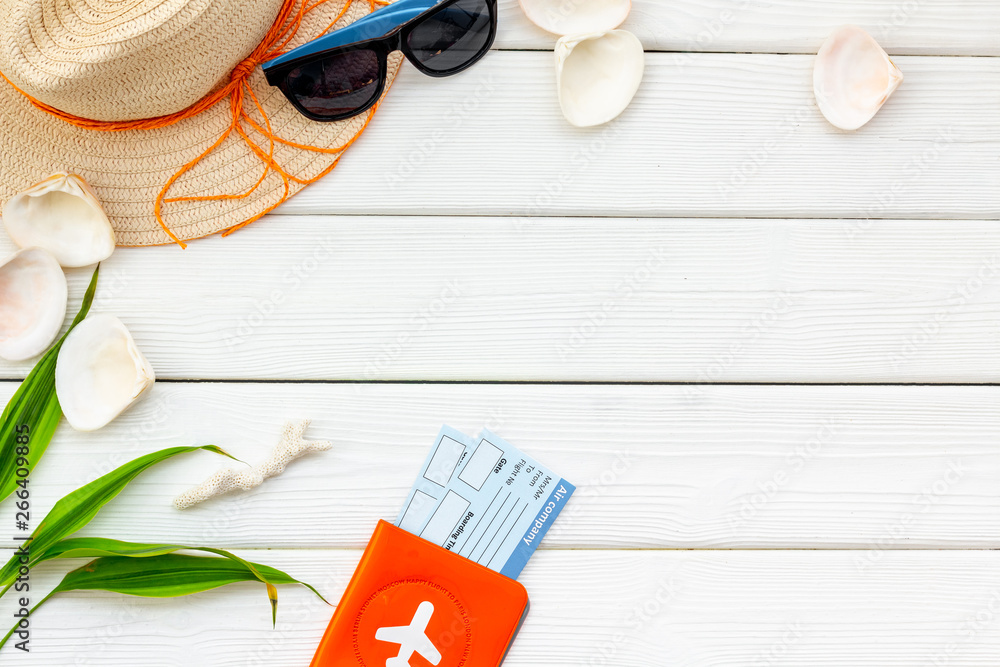 Summer travaling to the sea with straw hat, sun glasses, tickets and passport on white background top view mock up