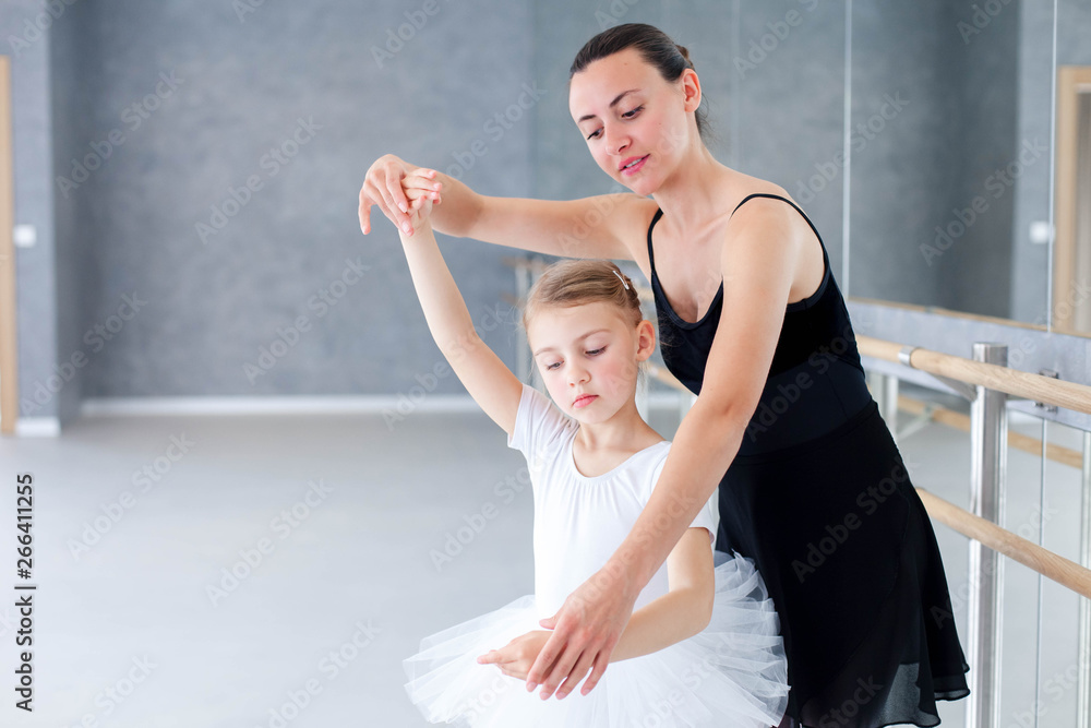 Ballet teacher and little ballerina have practice in classical dancing  school. Adult dance trainer is teaching kid girl to do children  choreographic exercises. Stock Photo | Adobe Stock