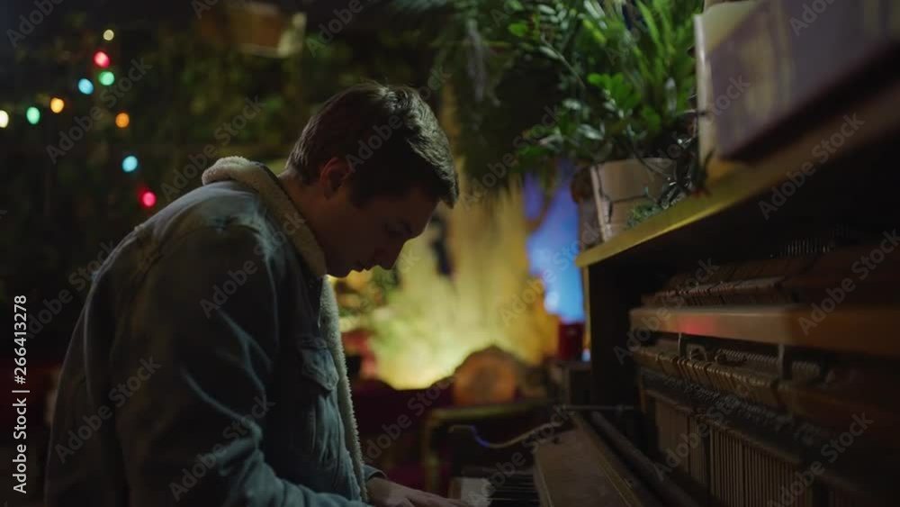 Tilt down to man playing piano in dark nightclub / Provo, Utah, United States Tilt down to man playing piano in dark nightclub / Provo, Utah, United States