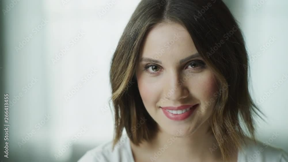 Close up portrait of smiling woman looking down then looking at camera / Cedar Hills, Utah, United States Close up portrait of smiling woman looking down then looking at camera / Cedar Hills, Utah, United States