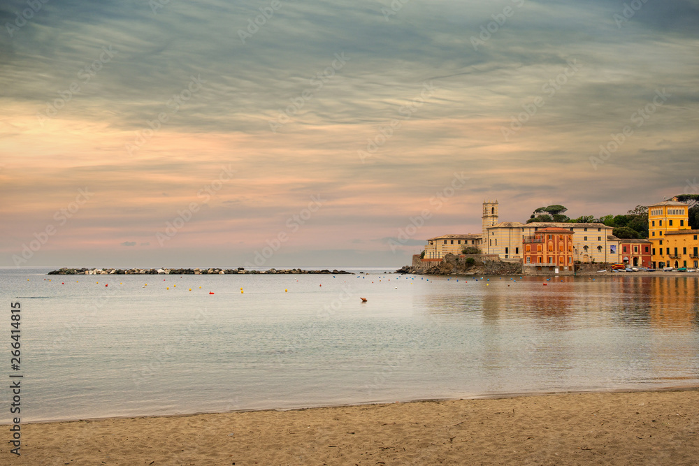Scenic view of the Bay of Silence, name coined in 1919 by the Ligurian poet Giovanni Descalzo (1902-1951), with the empty sandy beach in springtime at sunset, Sestri Levante, Genoa, Liguria, Italy