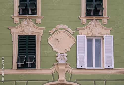 Εκτύπωση καμβά Close-up of the facade of an old building with bas-reliefs and a sundial with th