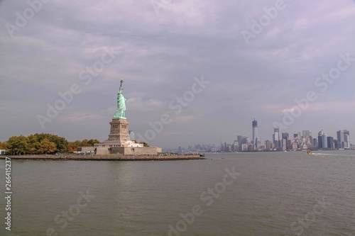 Beautiful view of famous Statue of Liberty and Manhattan on background. Liberty Island in New York Harbor in New York. © Alex