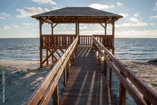 Fototapeta Naklejka Na Ścianę i Meble -  Very nice view of the access to the sea. Wooden sidewalk to the beach. Observation deck on the shores of the Baltic Sea.