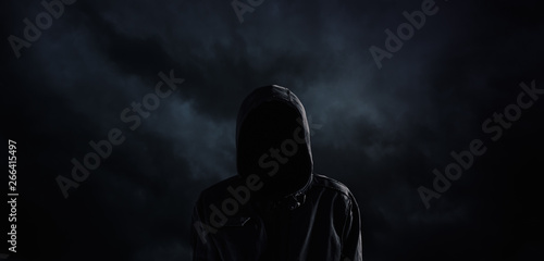 Spooky hooded person with obscured face photo