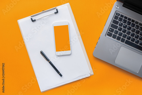 Clipboard notepad, smartphone and laptop computer