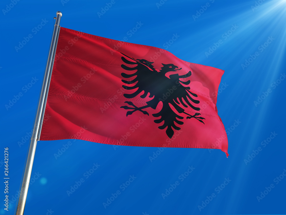 Albania National Flag Waving on pole against deep blue sky background. High Definition Albania National Flag Waving on pole against deep blue sky background. High Definition