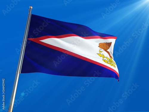 American Samoa National Flag Waving on pole against deep blue sky background. High Definition