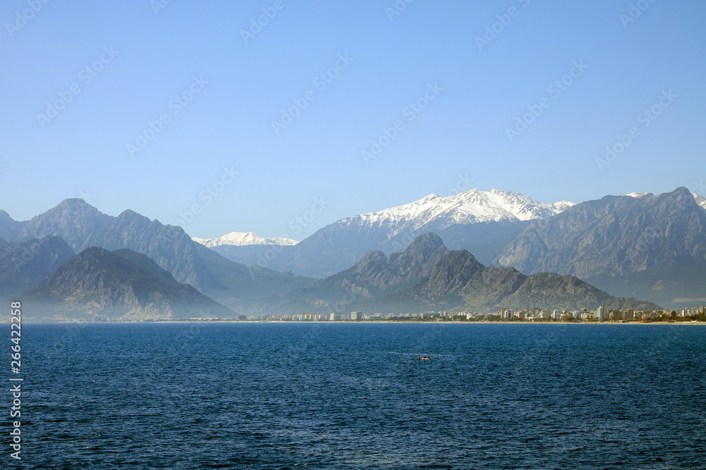 Mediterranean sea  and high mountains with snowy summit over clear blue sky in Antalya, Turkey