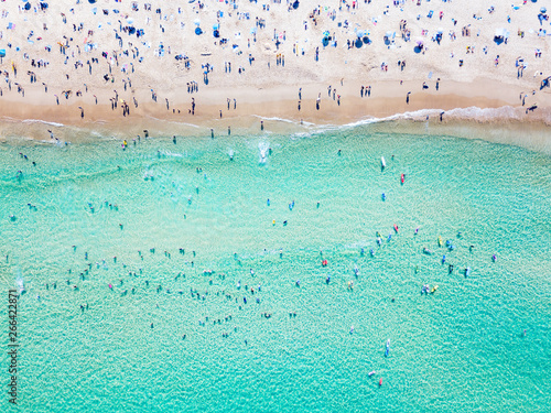 Bondi Beach aerial view on a perfect summer day with people swimming and sunbathing. Bondi is one of Sydney’s busiest beaches and is located on the East Coast of Australia