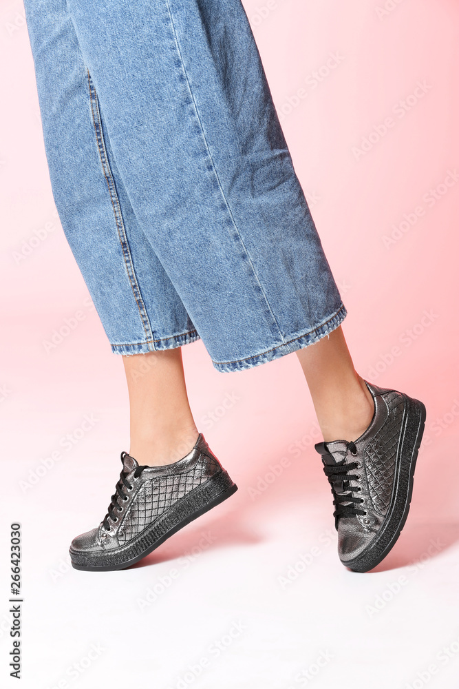 Woman in stylish shoes on color background, closeup Woman in stylish shoes on color background, closeup
