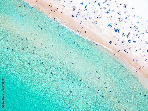 Bondi Beach aerial view on a perfect summer day with people swimming and sunbathing. Bondi is one of Sydney’s busiest beaches and is located on the East Coast of Australia