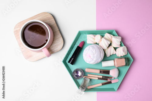 Flat lay composition with drink, sweets and cosmetics on color background © New Africa