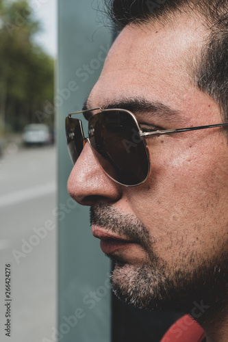 Indian man in sunglasses posing for the camera. 