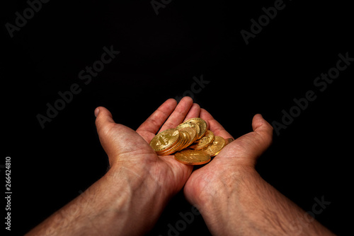 many golden coins in hand