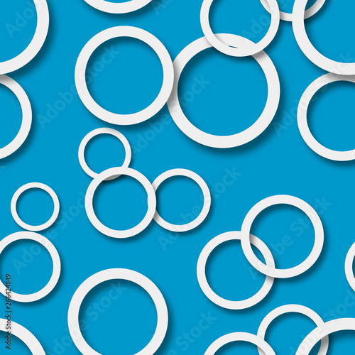 Abstract seamless pattern of randomly arranged white rings with soft shadows on light blue background