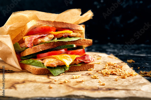 Freshly made clubsandwiches served on a wooden chopping board photo